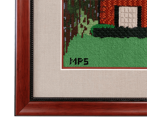 detail of home needlepoint in wooden fram